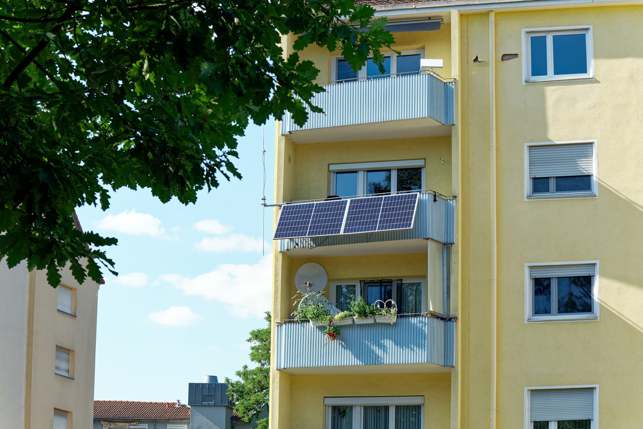 A balcony solar system on the exterior of an apartment block.